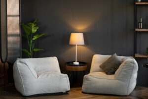 A pair of bean bags next to a stylish lamp, creating a relaxed seating area