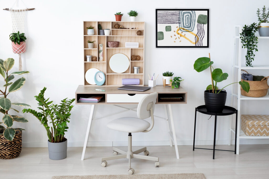 A desk with a chair, a shelf above, and a green plant on the desk, creating a tidy workspace