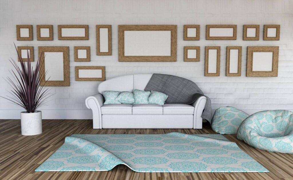 A cozy living room with a white sofa, decorative cushions, and multiple framed pictures on a white brick wall.