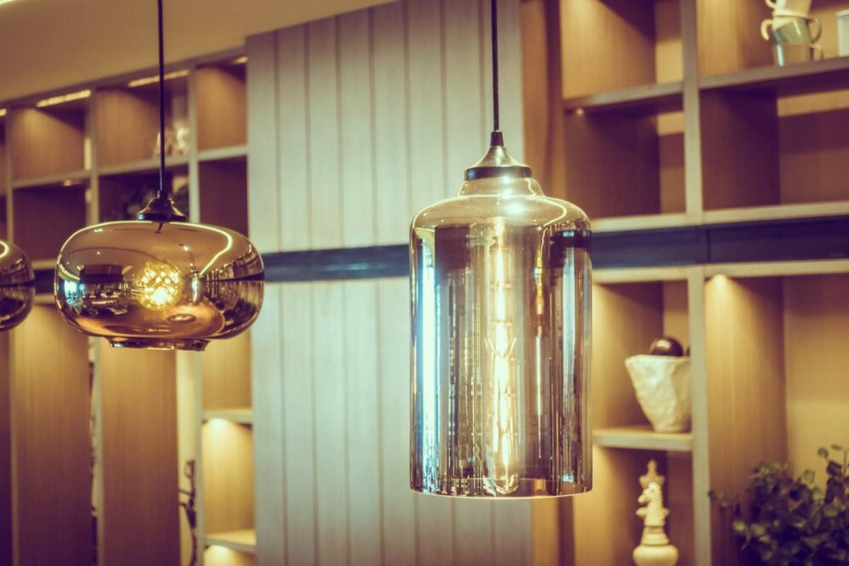 Modern pendant lights hanging in a stylish interior, featuring glass and metallic finishes.