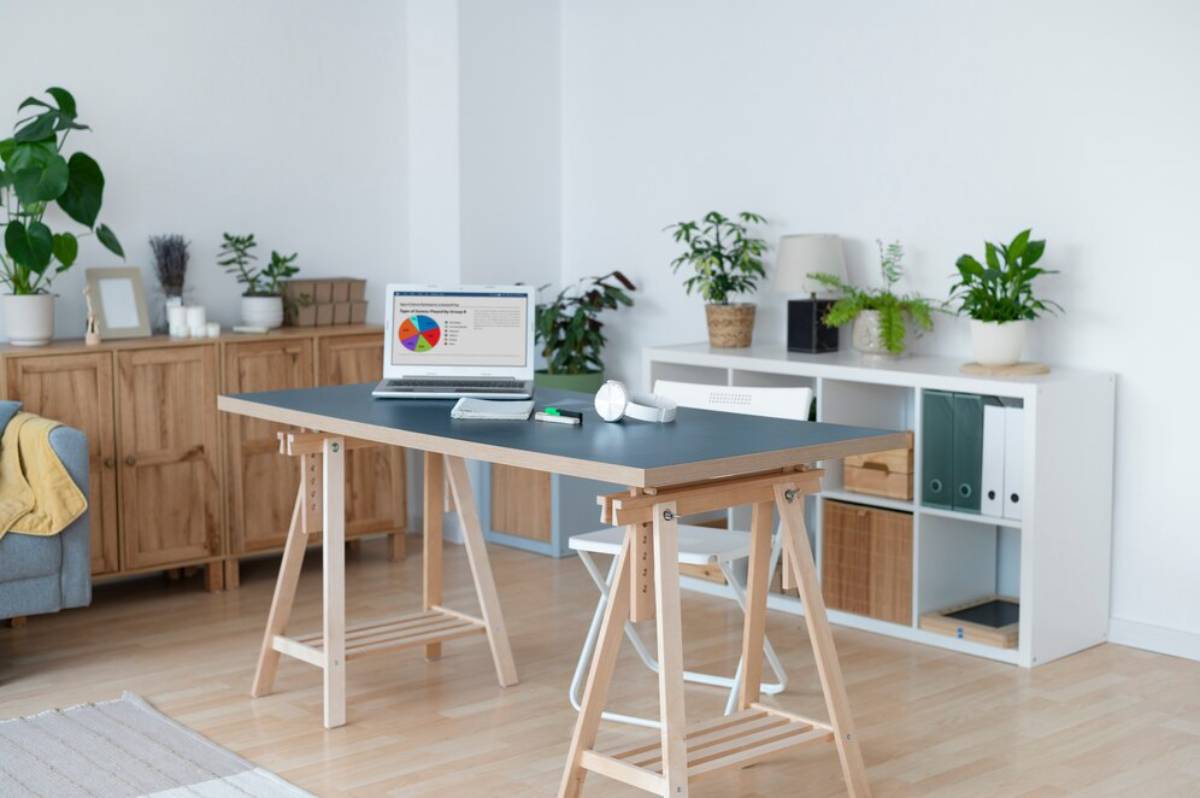 Modern home office with a laptop on a minimalist desk, surrounded by potted plants and wooden furniture.