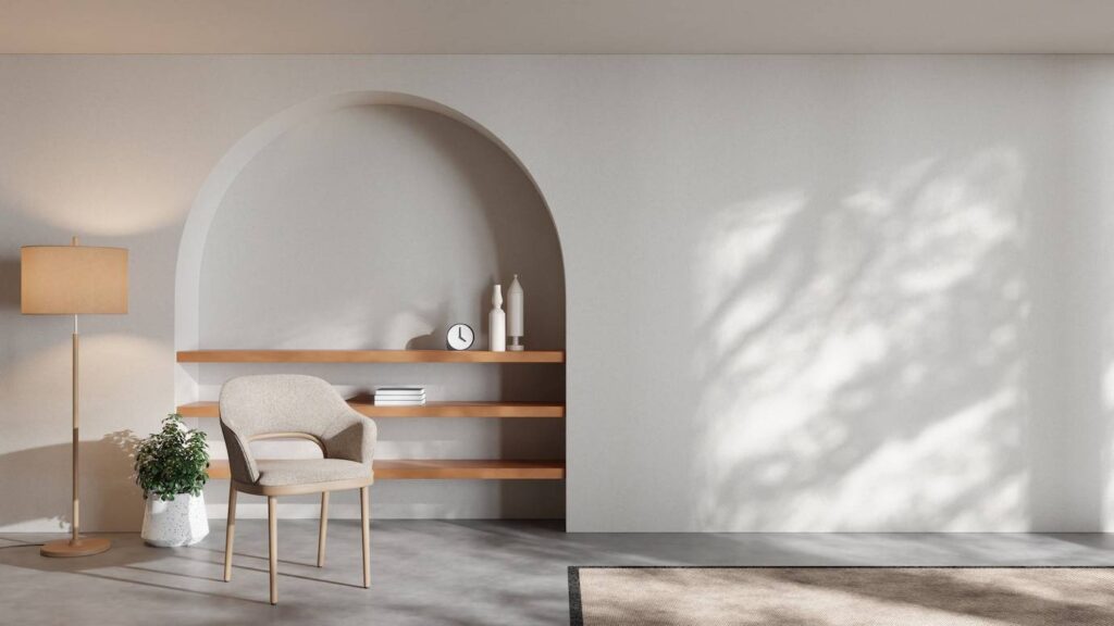 Modern minimalist living room with arched shelving, a chair, floor lamp, and shadow patterns on the wall.