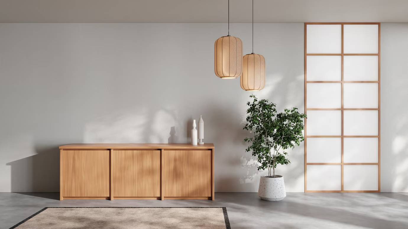 Modern minimalist living room with wooden furniture, hanging lamps, and a large potted plant near a shoji screen window.