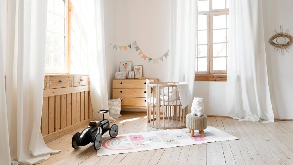 Bright and airy nursery with natural wood furniture, large windows, and playful decor.