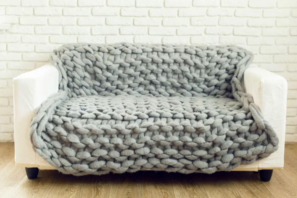 Wool cover over a white sofa in a drawing room